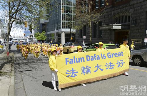 图5-11：五月八日，温哥华地区部分法轮功学员在温哥华市中心艺术馆庆祝法轮大法弘传世界三十周年，集会之后他们举行了游行活动（明慧网）